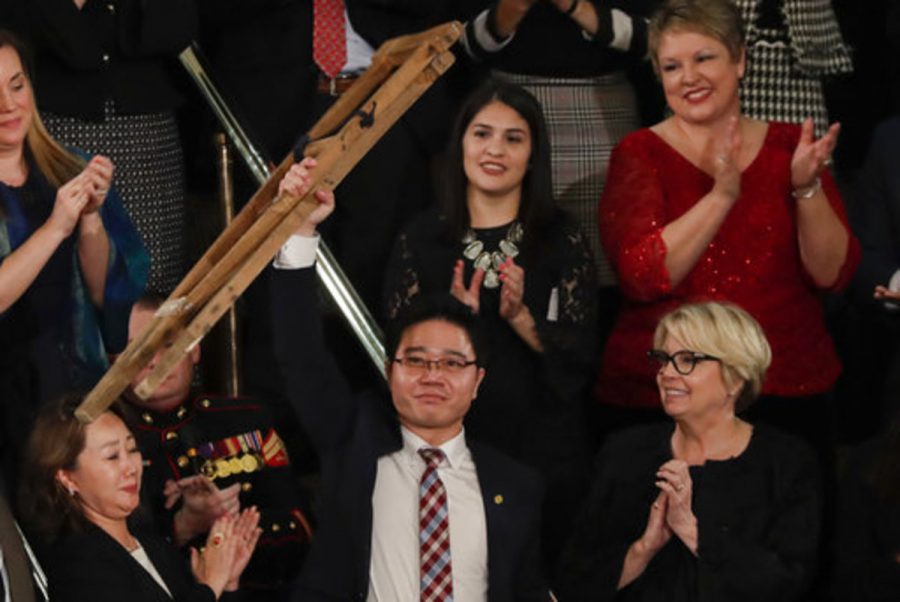 Ji Seong-ho raised his crutches above his head as President Trump honored him. 
