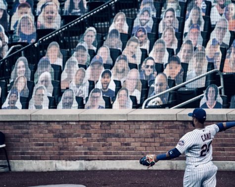 Robinson Canó throws in front of cardboard cutouts 