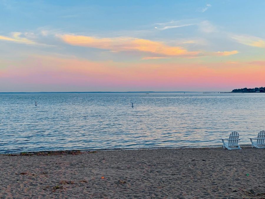 As you park your car and exit towards the main beach area, you sit on the sand and gaze at the Long Island Sound.