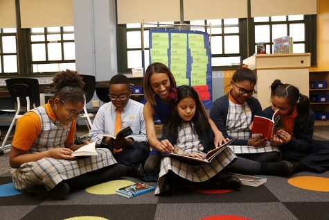 A teacher oversees reading students at a Charter School in New York City.