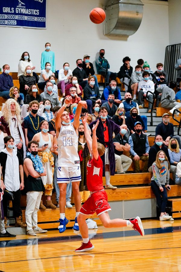 Darien’s Simeon Doll shoots a three pointer in front on the first Darien student section since fans returned.
Copyright Darien Athletic Foundation, https://darienaf.com