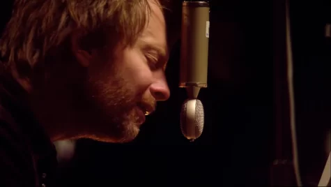 Lead singer of Radiohead, Thom Yorke, singing into a microphone at Radiohead's from the basement