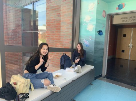 two girls sitting in hallway