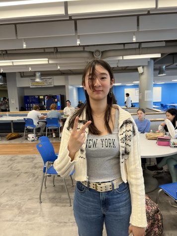 Student holding up peace sign in cafeteria