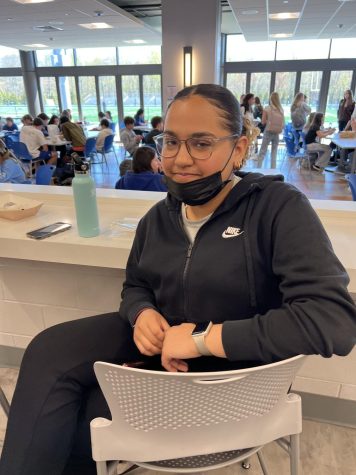 Student sitting at counter in cafeteria