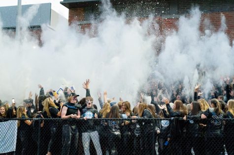 Darien student section throwing the flour before the game against Maloney earlier this season.