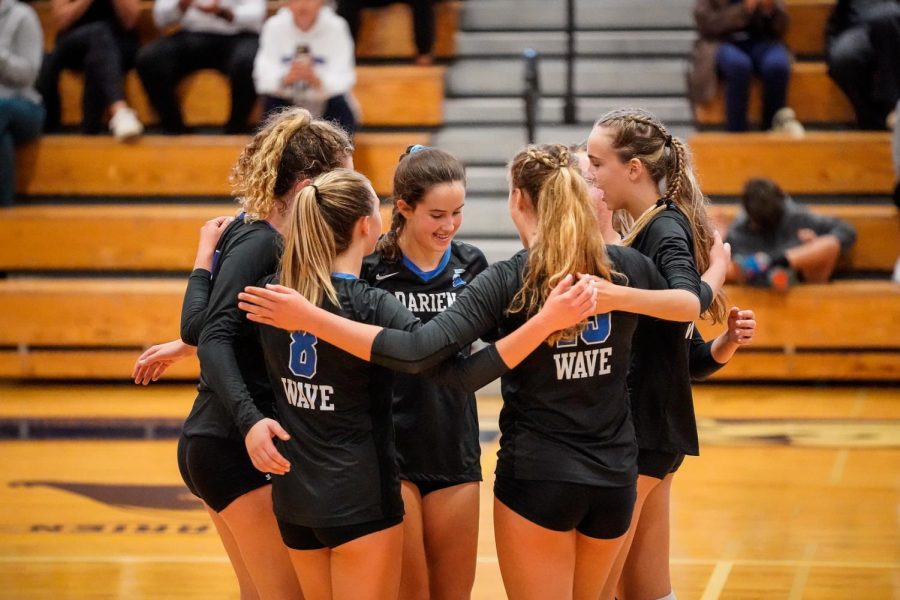 Darien Girls Volleyball team celebrating a point win (photo courtesy of DAF)