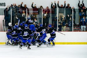 Darien celebrating a game winning goal vs. New Canaan in 2021