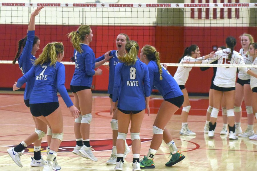 Darien Girls Volleyball celebrating the point win over the Greenwich Cardinals in the regular season win