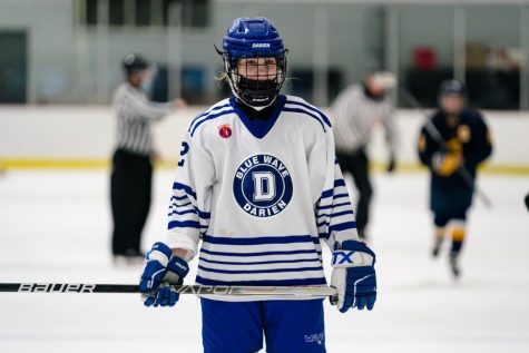 Darien forward Parker Krotee skating after a play during a 2022 regular season contest