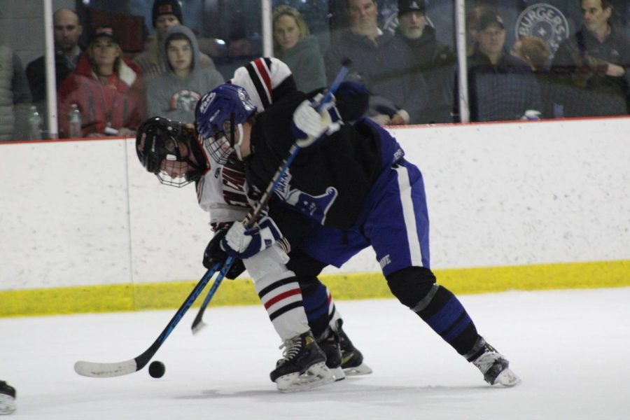 Dariens Elliot Lancaster laying a big hit on a New Canaan forward during the third period