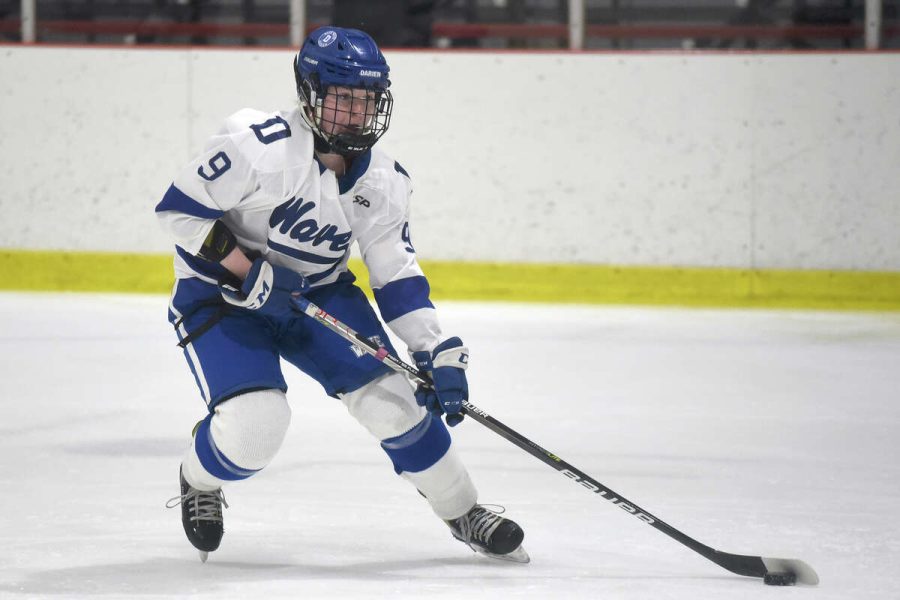 Dariens Sophomore Standout Natalie Beach controlling the puck in a win over SWS inside the Darien Ice House