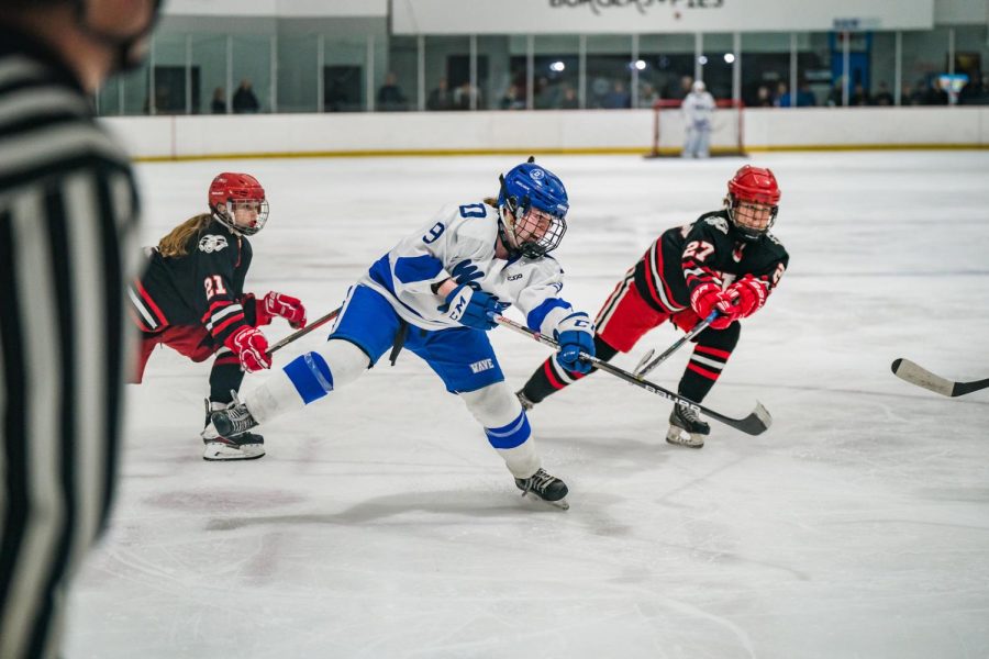 Darien sophomore Natalie Beach taking a shot in a game against the New Canaan Rams inside the Darien Ice House