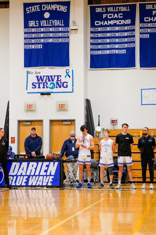 Darien Boys Basketball seniors Liam McBride, Isaac McMullen and Davis Depp addressing the crowd ahead of their game against New Canaan.