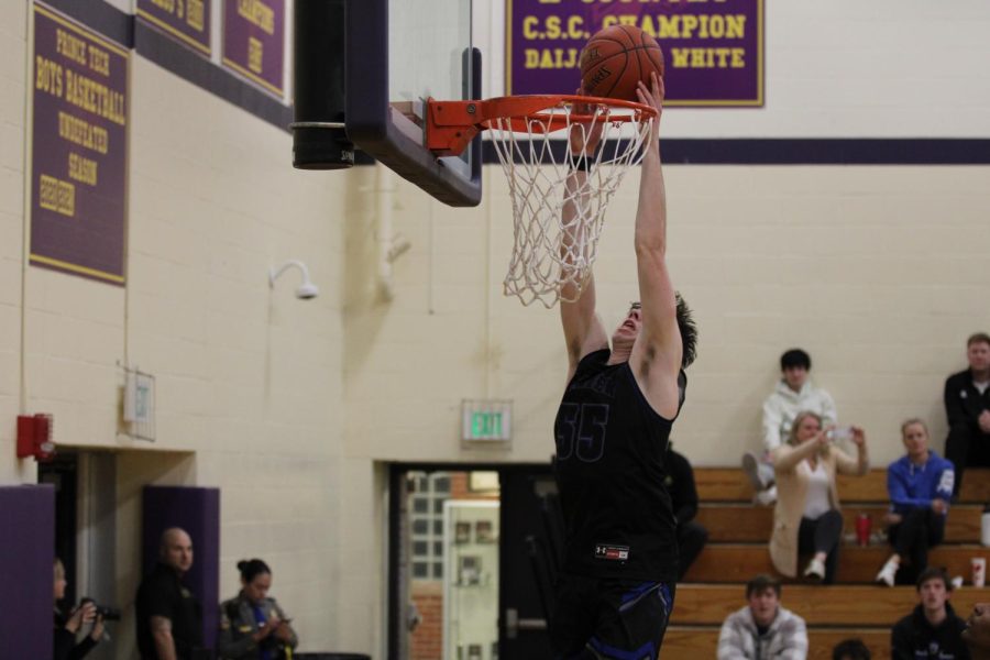 Darien junior center Jake Hendrickson dunking the ball in the first round of the CIAC state tournament at Prince Tech