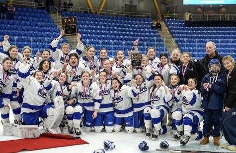 Darien celebrating as the 2023 Connecticut State Girls Ice Hockey champions inside the M&T Bank Arena
