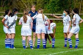 DHS Girls Rugby Head Coach Mr. Mark Stepis rallying his team up in a 2022 DHS Girls Rugby match at Hindley Elementary School.