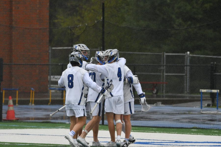Darien Boys Lacrosse celebrating a goal against arch rival New Canaan in 2023