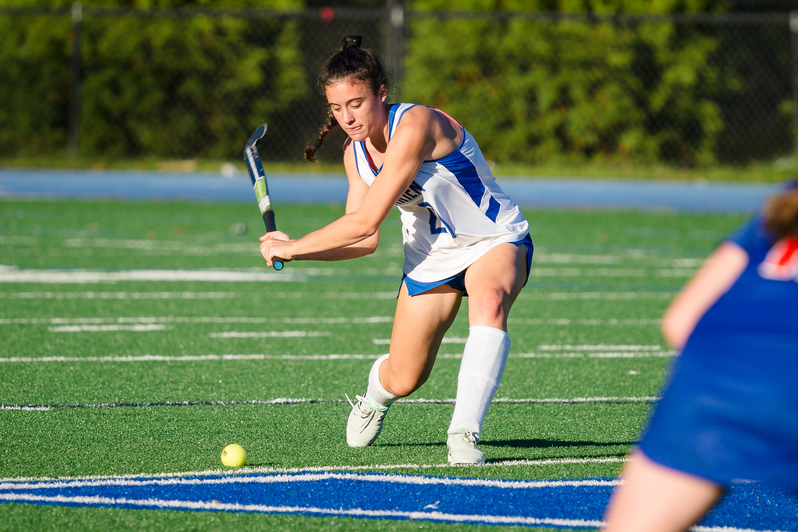 field hockey player about to strike ball