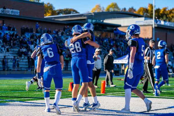 The Blue Wave Football team celebrating after a touchdown in the 2022 Homecoming Game against Greenwich - 10/29/22