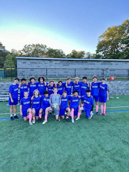 The ninth grade Boys Soccer Team posing with their kits on 