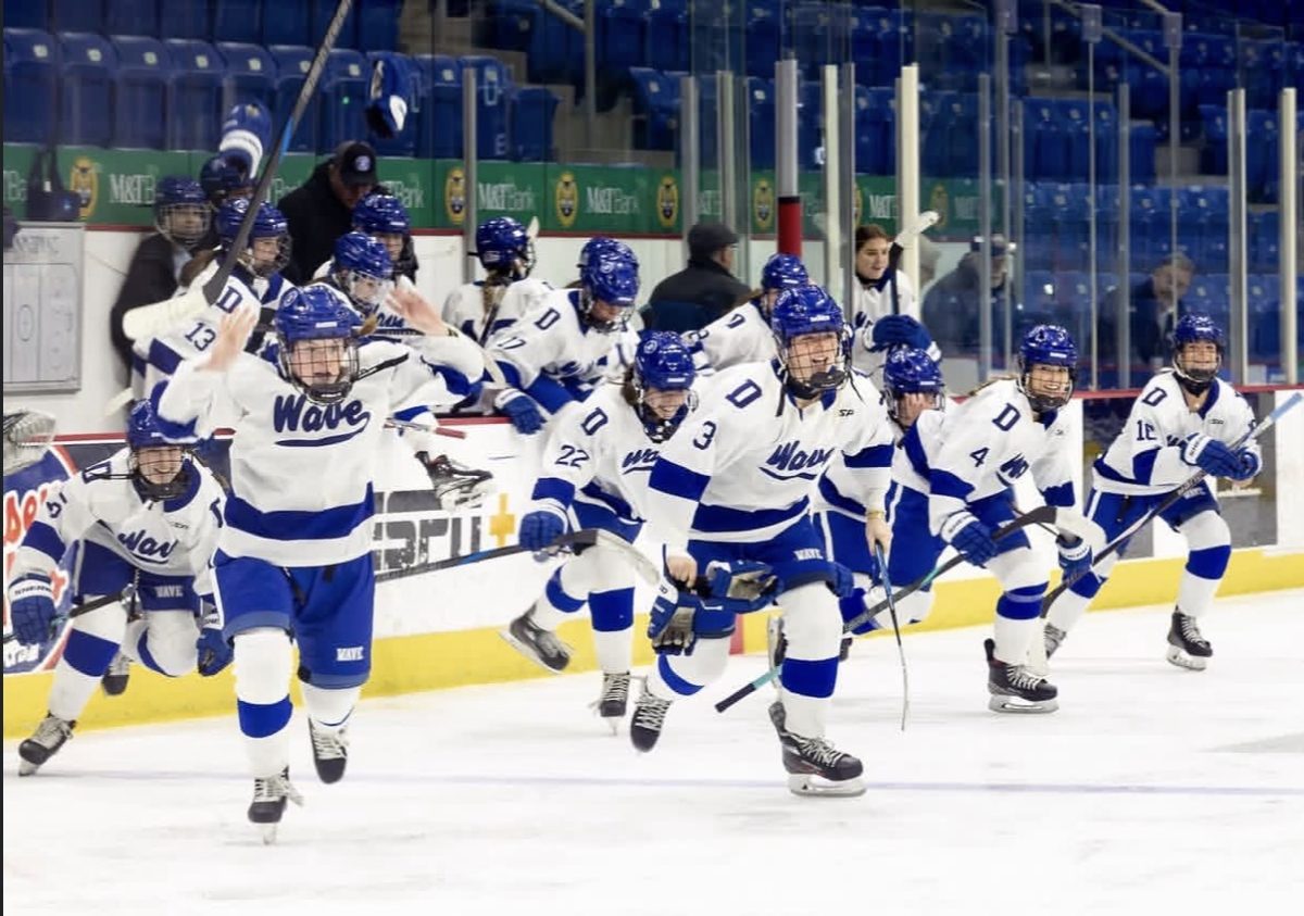 The Blue Wave Varsity Girls Hockey Team rushes the ice after claiming the State Championship on March 11th. Darien Photo credit: Instagram (@dariengirlswavepuck)