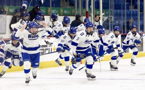 The Blue Wave Varsity Girls Hockey Team rushes the ice after claiming the State Championship on March 11th. Darien Photo credit: Instagram (@dariengirlswavepuck)